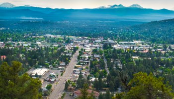 An aerial shot of Bend, Oregon, with the Cascade Mountains in the background.