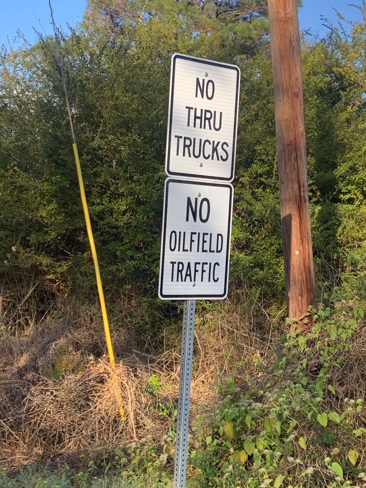Reading two signs "There are no trucks" And "No oil field traffic." Appears and is posted throughout DeSoto Parish.