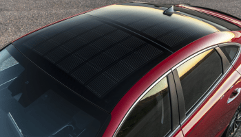 An aerial view of the solar panel roof of the Hyundai 2022 Sonata Hybrid, which has a bright red trim.