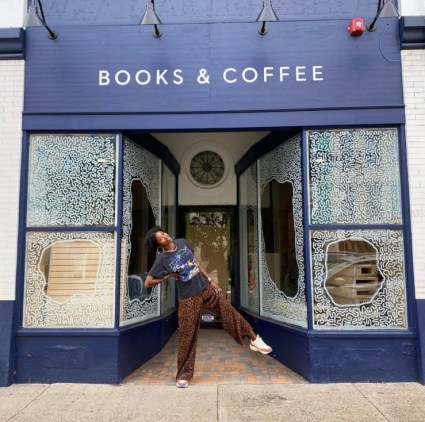 Atiya Jones in front of window drawings she created at White While Books in Pittsburgh, Pennsylvania.