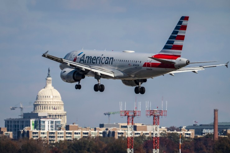An American Airlines airplane takes off at an airport.