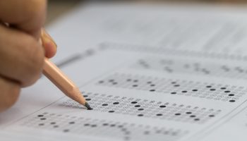 Person filling out a test bubble sheet