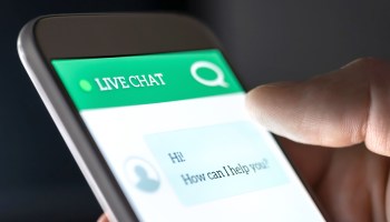 A person uses an automated live chat function on their phone.