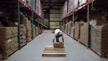 Planetary Design Warehouse Shipping Manager Will Klaczynski loads a pallet with boxes at the company's headquarters.
