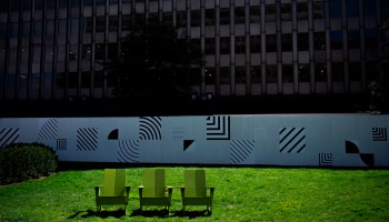 Empty chairs sit in the grass near a closed office building in Crystal City, where a majority of business have closed because of the coronavirus pandemic, in Arlington, Virginia on April 3, 2020.