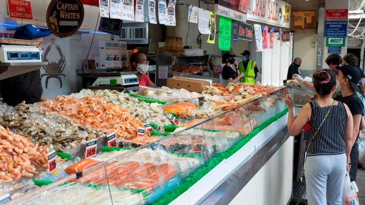Customers select seafood at the Municipal Fish Market in Washington, D.C., on May 29, 2020.