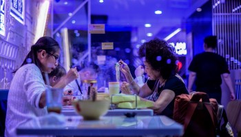 Chinese women eat at a restaurant in Hong Kong.