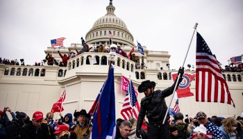Trump supporters holding American flags storm the U.S. Capitol on Jan. 6, 2021.