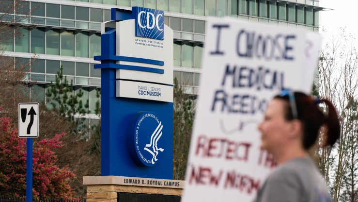 People are seen at a protest against masks, vaccines, and vaccine passports outside the headquarters of the Centers for Disease Control .