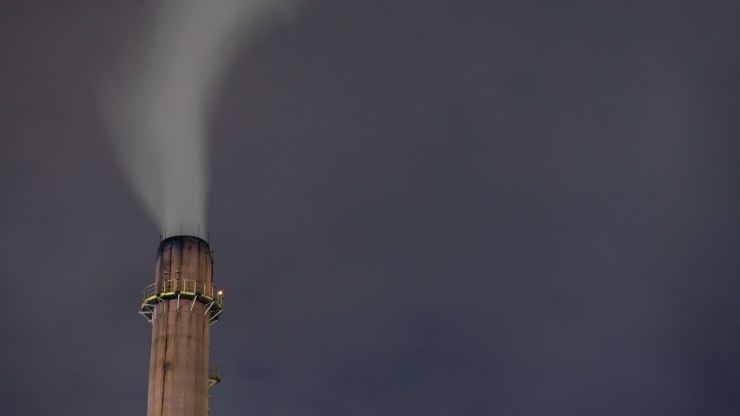 A factory chimney smokes at the Usiminas steel industrial complex, located at the city of Ipatinga, Minas Gerais state, Brazil, on November 5, 2021.