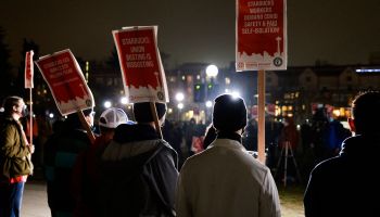 Representatives from local unions hold signs in support of workers of two Seattle Starbucks locations that announced plans to unionize, during an evening rally at Cal Anderson Park in Seattle, Washington, January 25, 2022.