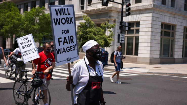 An activist with One Fair Wage walks down G Street during a “Wage Strike" demonstration on May 26th, 2021 in Washington, DC.