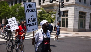 An activist with One Fair Wage walks down G Street during a “Wage Strike" demonstration on May 26th, 2021 in Washington, DC.