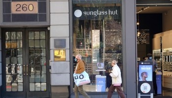 Shoppers pass by a Sunglasses Hut in San Francisco, CA.