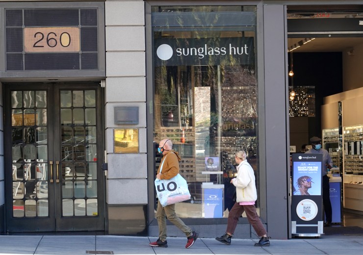 Shoppers pass by a Sunglasses Hut in San Francisco, CA.