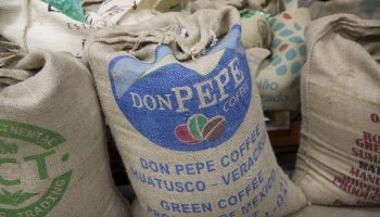 Burlap bags full of green coffee beans.