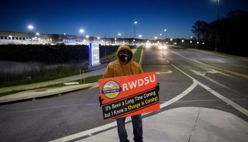 A union supporter stands before sunrise outside the Amazon fulfillment center on March 29, 2021 in Bessemer, Alabama.