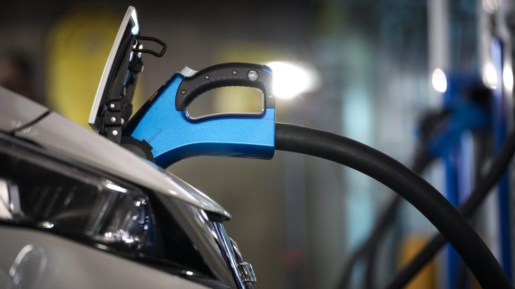 Closeup of an electric car charging.