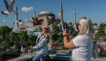 A Ukranian tourist poses for a picture near the Hagia Sophia Mosque