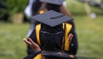 The cap of a former student of Jefferson County Public Schools can be seen as they clap within their row during a makeup graduation ceremony at Central High School on May 28, 2021 in Louisville, Kentucky.