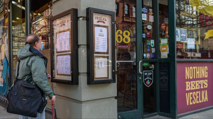 Person standing in front of the Ukrainian restaurant Veselka