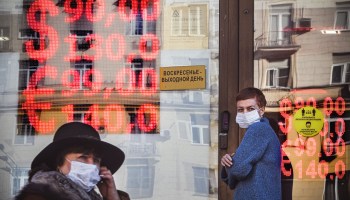 People walk past a currency exchange office in central Moscow on February 28, 2022.