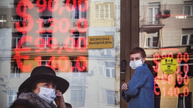 People walk past a currency exchange office in central Moscow on February 28, 2022.