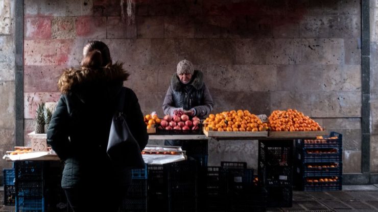 A woman sells fruit in an underground walkway in Kyiv.