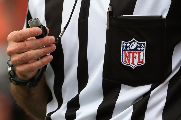 A detail of the uniform and whistle of an NFL referee.