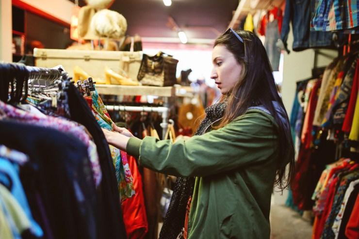 Young woman shops in a secondhand clothing store
