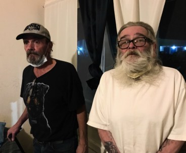 Chris Cox (left) and his brother Ronald pose for a picture in their motel room. 