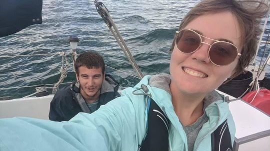 Sunni Blanning and Brandon Bunch on the sailboat they call home.