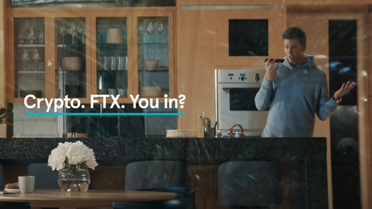 A screenshot shows Tom Brady on the phone in his kitchen with the text "Crypto. FTX. You in?"