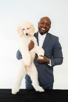 Brian Taylor with a white poodle. 