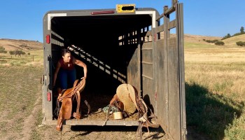 Cory Carman loads a saddle into a trailer at Carman Ranch in Wallowa, Oregon.
