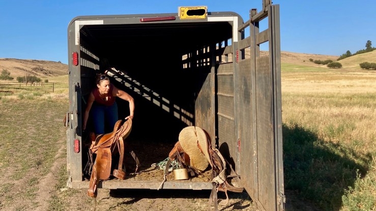 Cory Carman loads a saddle into a trailer at Carman Ranch in Wallowa, Oregon.