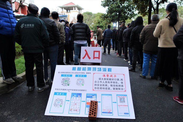 Residents in Shanghai  waiting for a PCR test. Social distancing is often not practiced at these mandatory mass testing sites (Charles Zhang/Marketplace)