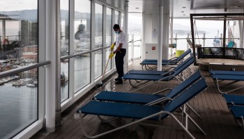A man cleans the deck on board of the Costa Smeralda cruise ship docked in Savona, near Genoa, on May 1, 2021.