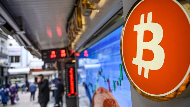 A bitcoin symbol is pictured at a cryptocurrency exchange branch near the Grand Bazaar in Istanbul on October 20, 2021.