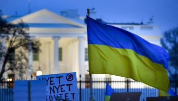 An activist holds the Ukraine national flag while protesting against the Russian invasion of Ukraine, in Lafayette Square in Washington, DC, on February 24, 2022.