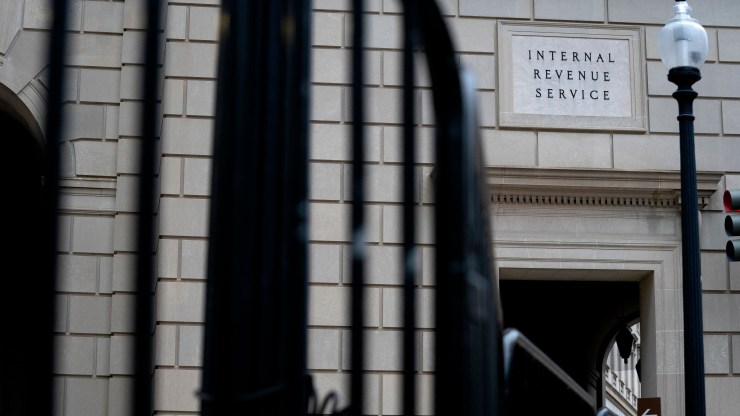 The Internal Revenue Service (IRS) building is seen through fence posts.