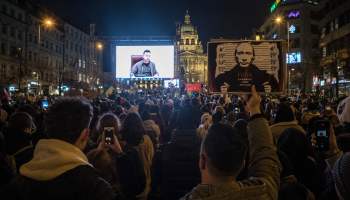 Protestors listen to a speech from Ukrainian President Volodymyr Zelenskyy screened during a demonstration against Russia's invasion of Ukraine, on March 4, 2022 at the Venceslas square in Prague, Czech Republic.
