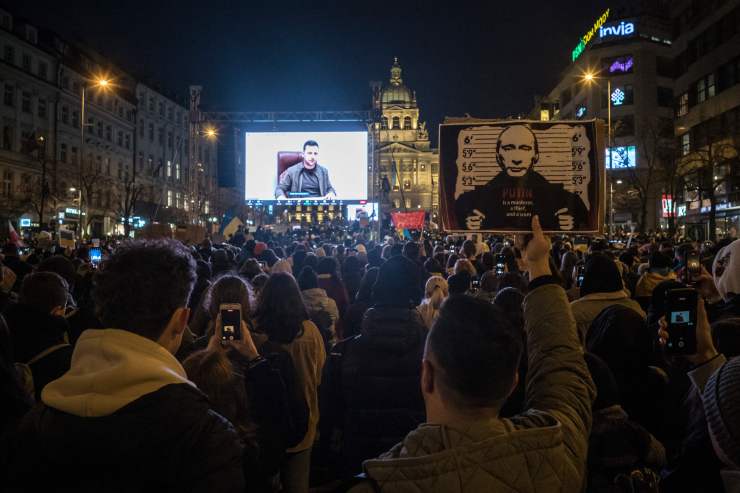 Protestors listen to a speech from Ukrainian President Volodymyr Zelenskyy screened during a demonstration against Russia's invasion of Ukraine, on March 4, 2022 at the Venceslas square in Prague, Czech Republic.
