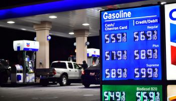 Prices listed at a gas station show rising fuel costs.
