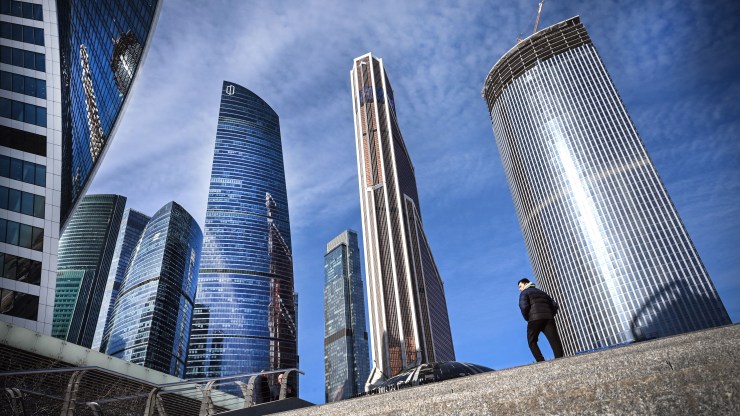 A man walks in front of Moscow's International Business Centre (Moskva City) complex in Moscow on March 11, 2022. -