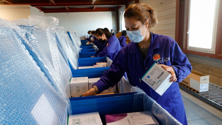 A volunteer prepares boxes of medicine to be sent to Ukraine.