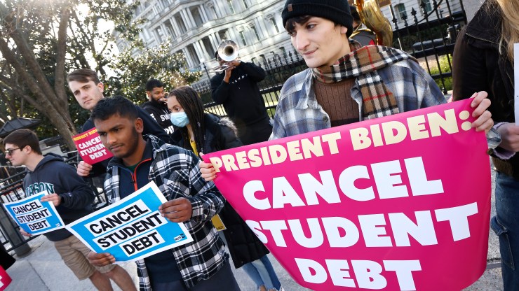 Activists protect for student debt cancellation outside of the White House.