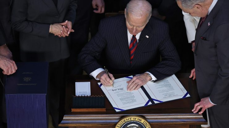 President Biden signs the Consolidated Appropriations Act on March 15 to fund the U.S. government, which also sent $13.6 billion in aid to Ukraine.
