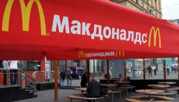 People sit on the terrace of a closed McDonald's restaurant in Moscow.