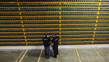 Two technicians inspect bitcoin mining at Bitfarms in Saint Hyacinthe, Quebec on March 19, 2018.